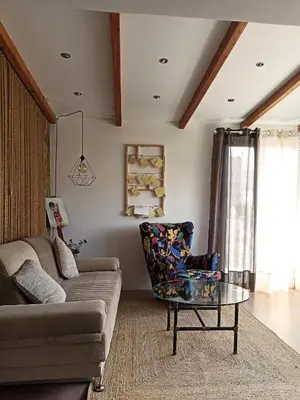 a living room with a couch and a glass table at Terrace holiday studio apartment in Athens