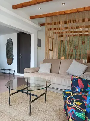a living room with a couch and a glass table at Terrace holiday studio apartment in Athens