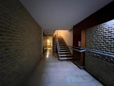 a hallway with stairs and a brick wall at Stylish City Studio 8' From 3 Metro Lines 4th Floor in Athens