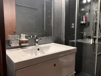 a bathroom with a white sink and a mirror at Stylish City Studio 8' From 3 Metro Lines 4th Floor in Athens