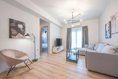 a living room with a couch and a chair at Superior & Spacious Apartment in Athens