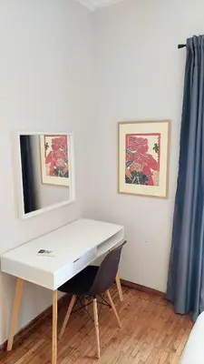 a white desk with a chair in a room at Best Acropolis museum apartment in Athens