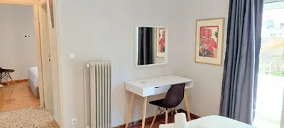 a white room with a desk and a chair at Best Acropolis museum apartment in Athens
