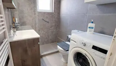 a bathroom with a washing machine and a sink at Best Acropolis museum apartment in Athens