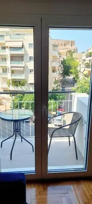 a glass door leading to a patio with a table at Best Acropolis museum apartment in Athens