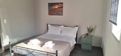 a bedroom with a bed with two towels on it at Studio pellinis in Athens