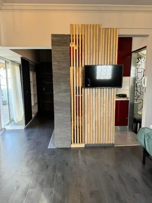 a living room with a tv on a wall at Studio pellinis in Athens