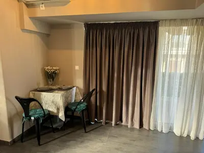 a dining room with a table and chairs and a window at Studio pellinis in Athens