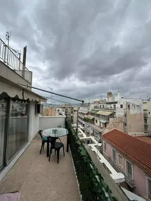 a patio with a table and chairs on a balcony at Studio pellinis in Athens