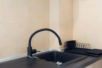 a kitchen sink with a faucet on top of it at Athens Center Boho Apartment in Athens