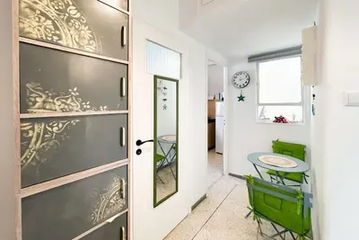 a dining room with a table and a door at Athens Center Boho Apartment in Athens