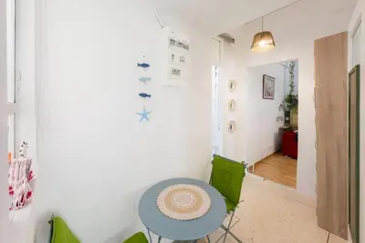 a dining room with a blue table and green chairs at Athens Center Boho Apartment in Athens