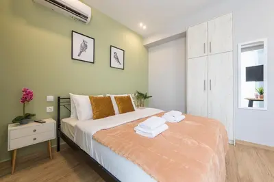 a bedroom with a bed with towels on it at Top Ten Apartment 3 in Athens