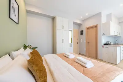 a bedroom with a large bed with two pillows on it at Top Ten Apartment 3 in Athens