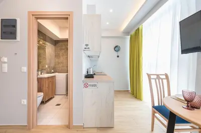 a kitchen and a dining room with a table and a dining room at Top Ten Apartment 3 in Athens