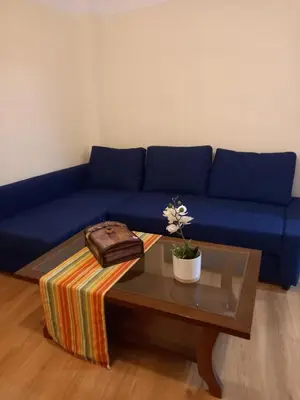 a blue couch with a coffee table and a purse at Underground treasure in Athens
