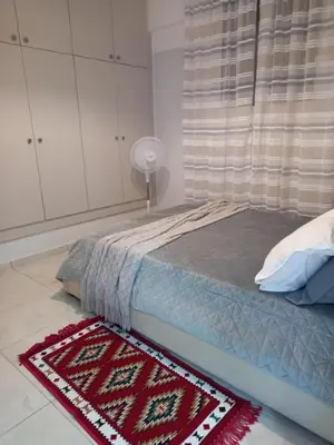 a bedroom with a bed with a rug on the floor at Underground treasure in Athens