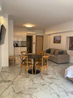 a living room with a table and chairs and a couch at Syntagma Luxury Suite by CK-1 in Athens