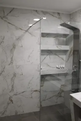 a shower with a glass door in a bathroom at Syntagma Luxury Suite by CK-1 in Athens