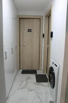 a bathroom with a door and a washing machine at Syntagma Luxury Suite by CK-1 in Athens