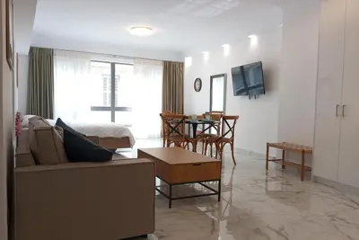 a living room with a couch and a table at Syntagma Luxury Suite by CK-1 in Athens