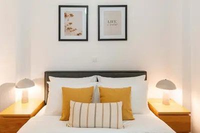 a bedroom with a bed with two lamps at Phaedrus Living Alimos Edem Beach Flat in Athens