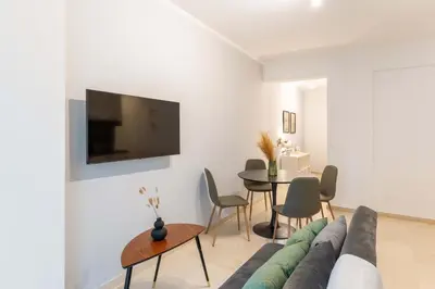 a living room with a couch and a table at Phaedrus Living Alimos Edem Beach Flat in Athens