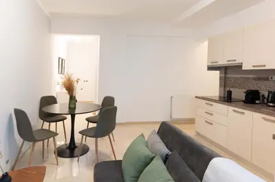 a living room with a couch and a table at Phaedrus Living Alimos Edem Beach Flat in Athens