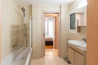 a bathroom with a shower and a tub and a sink at Phaedrus Living Alimos Edem Beach Flat in Athens