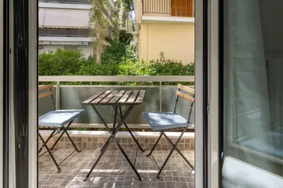 a table and two chairs sitting on a balcony at Phaedrus Living Alimos Edem Beach Flat in Athens