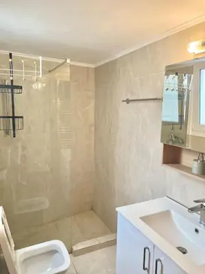 a bathroom with a shower and a toilet and a sink at Cozy 3BRs Family Haven near Metro&Acropolis in Athens