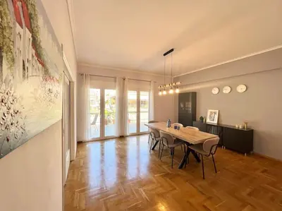 a dining room with a table and some chairs at Cozy 3BRs Family Haven near Metro&Acropolis in Athens