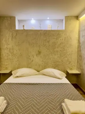 a bedroom with a bed with two pillows at Villa Anastasia in Athens