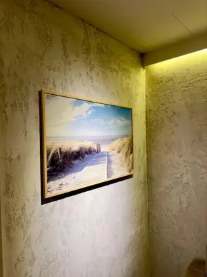 a picture hanging on a wall in a room at Villa Anastasia in Athens