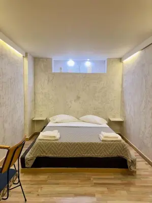 a bedroom with a bed and a chair in it at Villa Anastasia in Athens
