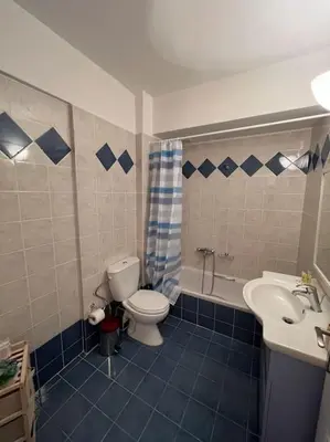 a bathroom with a toilet and a sink at Comfortable apartment at skouze hill in Athens