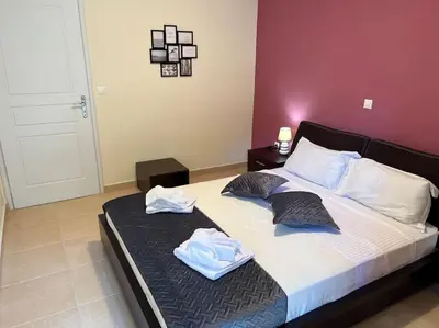 a bedroom with a bed with two towels on it at Comfortable apartment at skouze hill in Athens