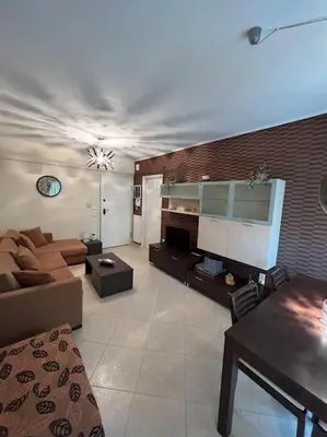 a living room with a couch and a table at Comfortable apartment at skouze hill in Athens