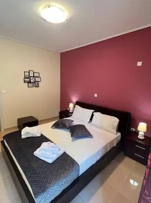a bedroom with a large bed with two towels on it at Comfortable apartment at skouze hill in Athens