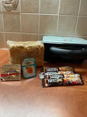 a counter with a suitcase and some snacks and a box at Comfortable apartment at skouze hill in Athens