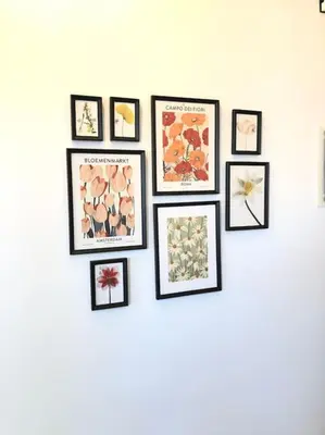 a group of framed pictures on a wall at 3BD apartment with Acropolis & Temple of Zeus view in Athens