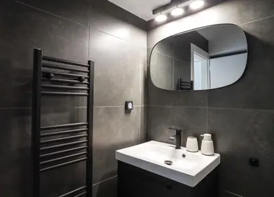 a bathroom with a sink and a mirror at 3BD apartment with Acropolis & Temple of Zeus view in Athens
