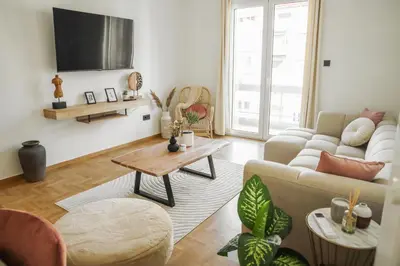 a living room with a couch and a table at 3BD apartment with Acropolis & Temple of Zeus view in Athens