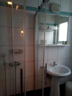 a bathroom with a shower and a sink at Zappion Hotel in Athens