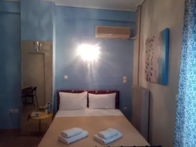 a bedroom with a bed with two towels on it at Zappion Hotel in Athens