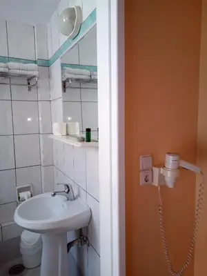 a bathroom with a sink and a toilet at Zappion Hotel in Athens