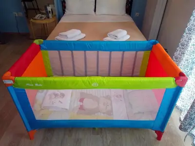 a colorful crib in a room with a bed at Zappion Hotel in Athens
