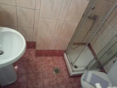 a bathroom with a shower and a toilet and a sink at Zappion Hotel in Athens