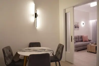 a living room with a table and chairs and a couch at Bright & Cozy Apartment, Athens in Athens