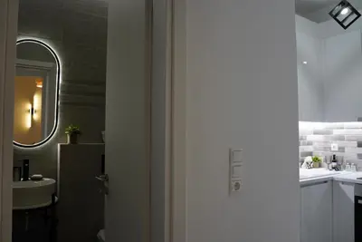 a white bathroom with a sink and a mirror at Bright & Cozy Apartment, Athens in Athens
